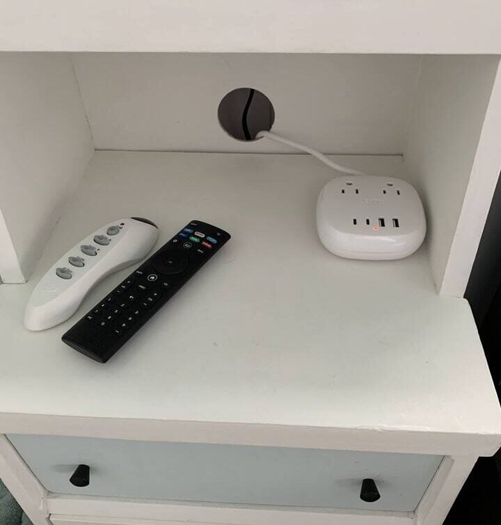 Two remote controls and a power outlet