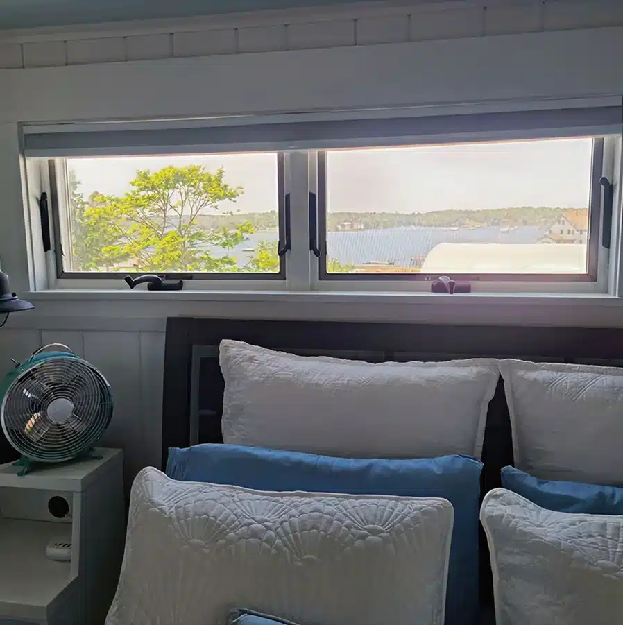 Cozy bedroom with scenic window view of Boothbay harbor