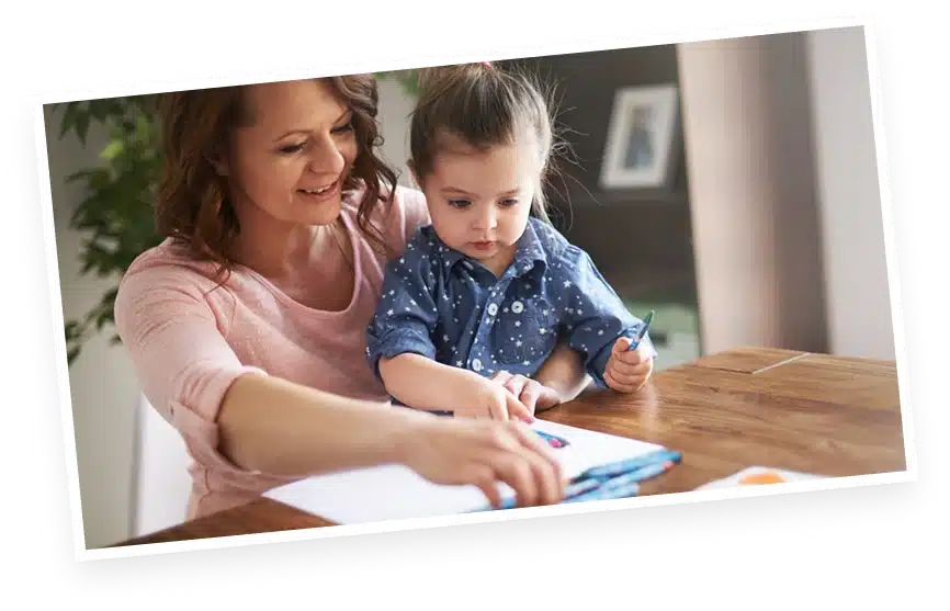 Adult and child engaged in drawing