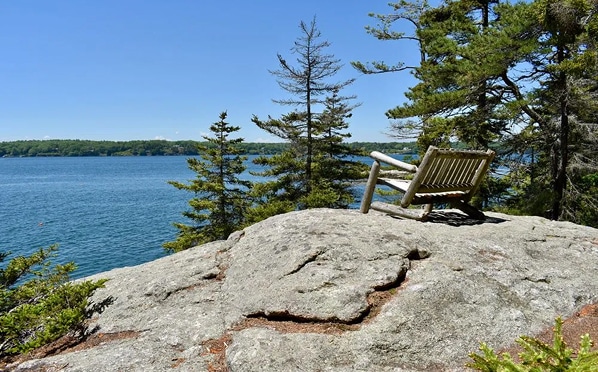 Lone chair overlooking serene water