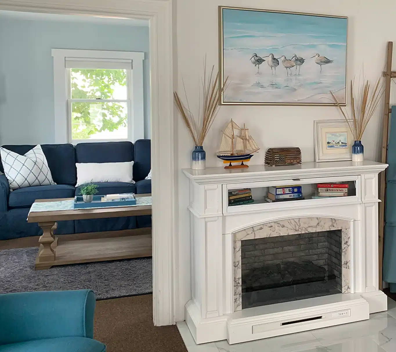 Cozy living room with fireplace at The Helm House in Boothbay Harbor Maine