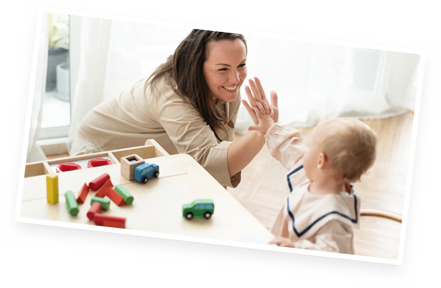 Child playing with toys and caregiver