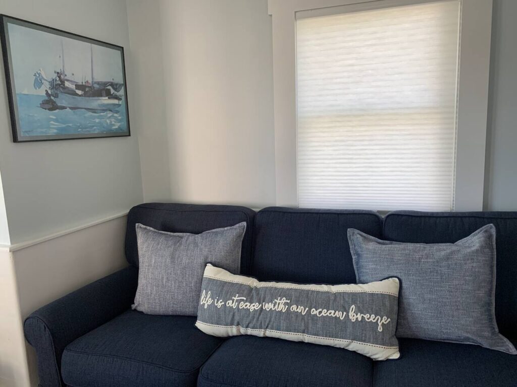 Cozy sofa with ocean-themed decor.