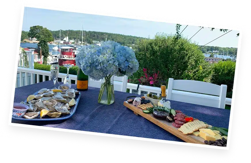 Outdoor dining with harbor views at The Helm House in Boothbay Harbor Maine